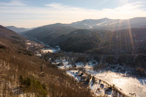 a view of a valley with a river and mountains at Luxury Condo Tucked in the Heart of Killington in Killington