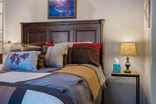 a bed with a wooden headboard in a bedroom at Luxury Condo Tucked in the Heart of Killington in Killington