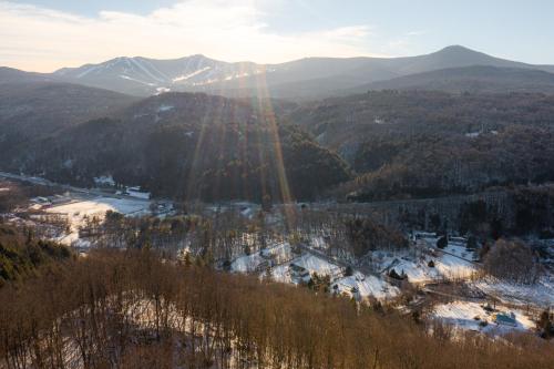 a view of a valley with snow and mountains at Luxury Condo Tucked in the Heart of Killington in Killington