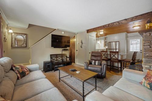 a living room with a couch and a table at Luxury Condo Tucked in the Heart of Killington in Killington