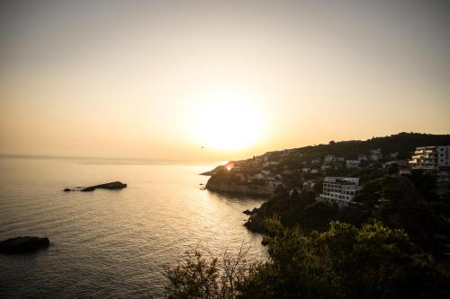 a view of the sun setting over the water at Villa Terra Promessa in Ulcinj