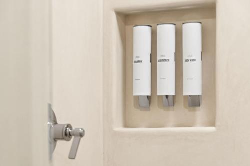 ajar door with five white cards in it at Casa Riviera - Boutique Suites in Downtown Santa Barbara in Santa Barbara