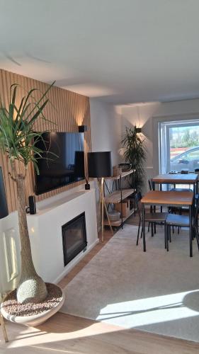 a living room with a fireplace and a table and chairs at Casa de Moledo Beach, Spa & Sauna in Moledo