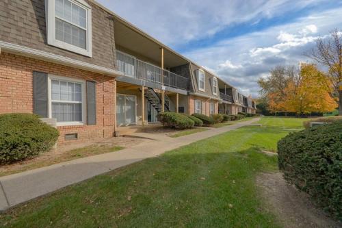 a brick building with a sidewalk in front of it at Landing Apartments - Castleton in Indianapolis