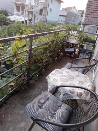 a balcony with chairs and a table on a balcony at Nada Apartman in Lastva