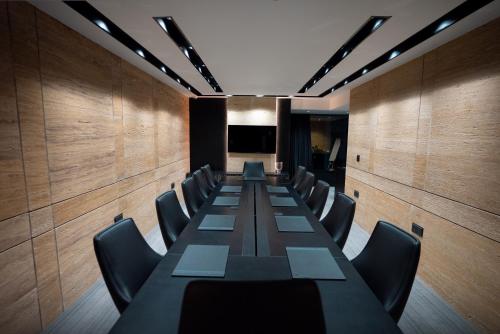 a conference room with a long table and chairs at The V Hotel in Baghdad