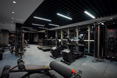 a gym with a bunch of treadmills and machines at The V Hotel in Baghdad