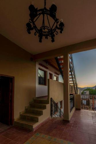 a chandelier hangs above a staircase in a house at Tala Huasi in Tilcara