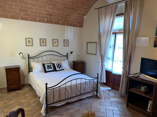 a bedroom with a bed with two pictures on it at Fattoria Fibbiano in Terricciola