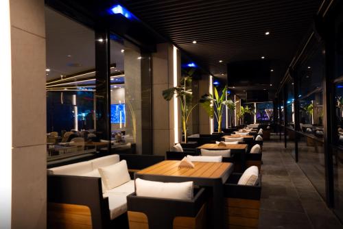 a restaurant with a long line of chairs and tables at The V Hotel in Baghdad