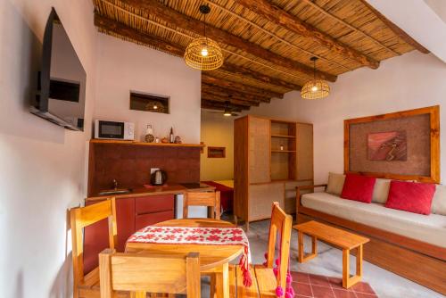a room with a table and a bed and a dining room at Tala Huasi in Tilcara
