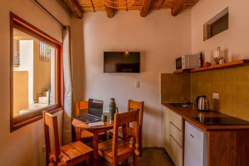 a kitchen with a table with a laptop on it at Tala Huasi in Tilcara