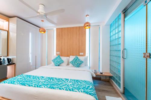 a hotel room with a bed and a window at Hotel Star Shell in Hulhumale