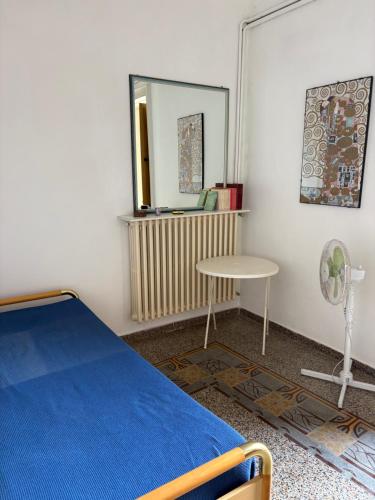a bedroom with a bed and a mirror and a table at Loft Incantevole in Peschici