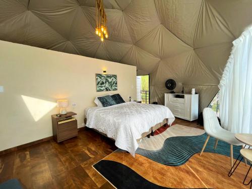 a bedroom with a bed in a tent at Sweet Forest Glamping in Sucre