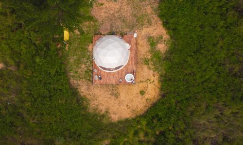 an aerial view of a car parked in a field at Sweet Forest Glamping in Sucre