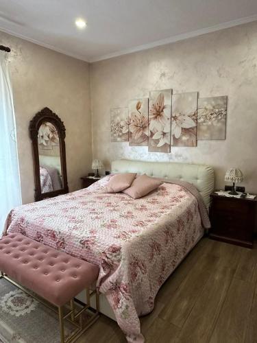 a bedroom with a large bed and a mirror at B&B Corvara in Nettuno