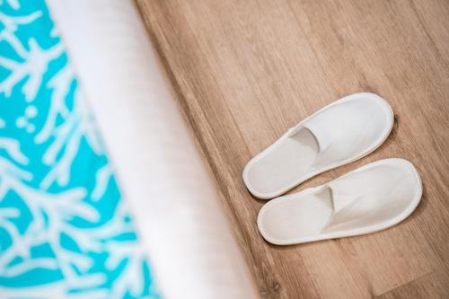 a pair of white flip flops sitting on a table at Hotel Star Shell in Hulhumale