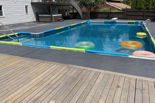 a pool with four frisbees in the water at Wakefield sweet home in Wakefield