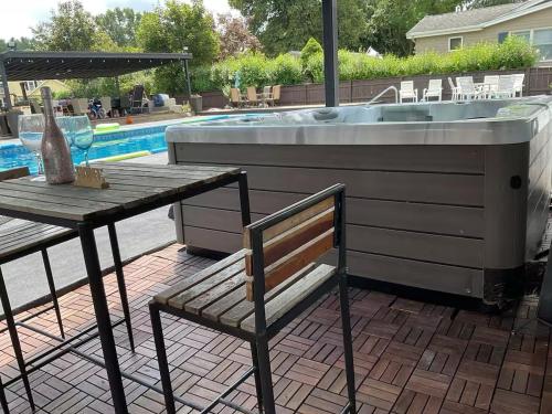 a patio with a sink and a table and a bench at Wakefield sweet home in Wakefield