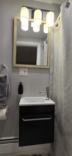 a bathroom with a sink and a mirror at Wakefield sweet home in Wakefield