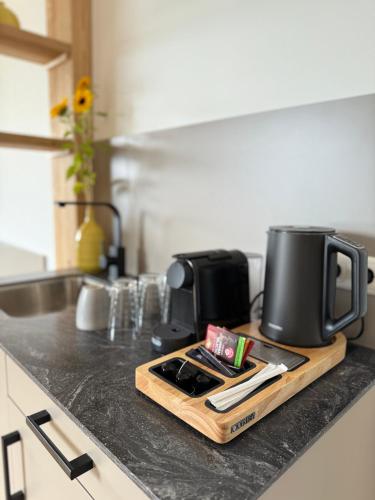 a kitchen counter with a coffee maker on a cutting board at Seehotel Lilly in Strobl