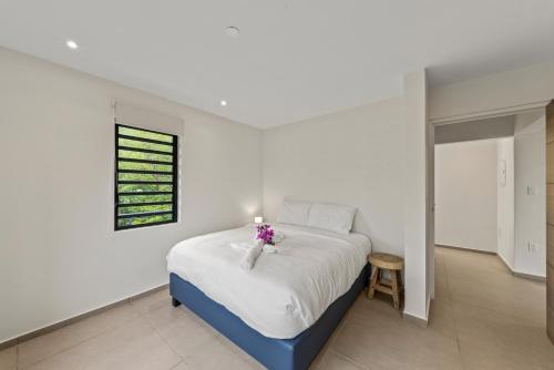 a bedroom with a bed with a candle on it at Vista Papaya Suites in Westpunt