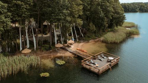 an aerial view of a boat in the water at Akmenos Villas & Bungalow in Bražuolė