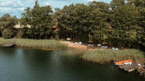 a view of a lake with boats in the water at Akmenos Villas & Bungalow in Bražuolė