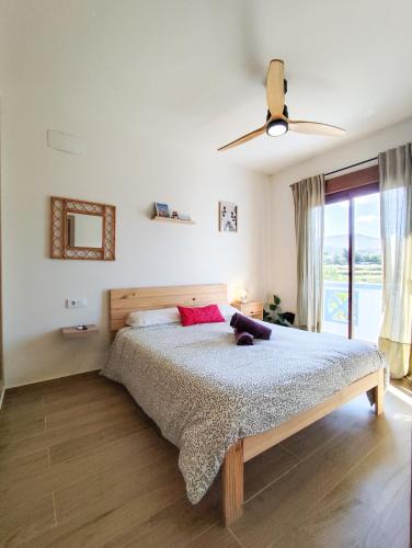 a bedroom with a bed and a ceiling fan at l'Alqueria de Laguar - Casa rural al Barranc de l'Infern in Benimaurell