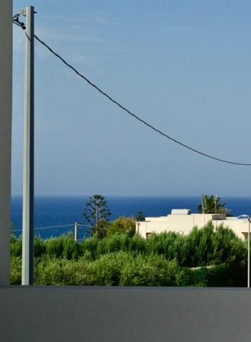 a telephone pole with the ocean in the background at Casa nel Sud-Est in Cava dʼAliga