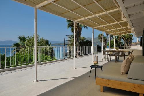 an outdoor patio with a couch and a table at Evia Bay Suites and Retreats in Edipsos