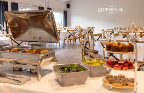 a buffet line with food on a table at voco The Club - Dublin Gateway by IHG in Naas
