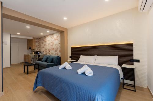 a bedroom with a blue bed with towels on it at Emily Suites in Benidorm