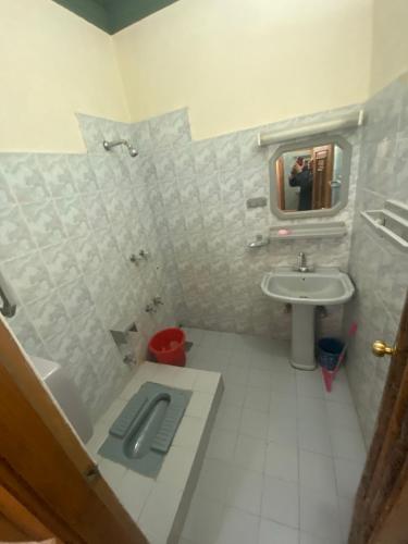 a small bathroom with a sink and a toilet at Taimoor Hotel swat Kalam in Kalām