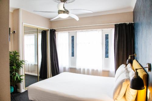 a bedroom with a bed and a large window at The Montana in Torquay