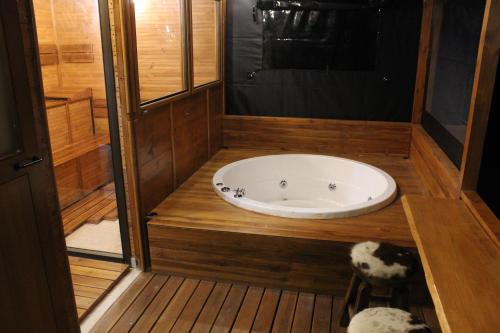 a bathroom with a tub in the middle at Cielo Verde Wood House 