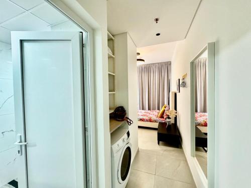 a bathroom with a washing machine in a room at Stunning studio with balcony close to metro in Dubai