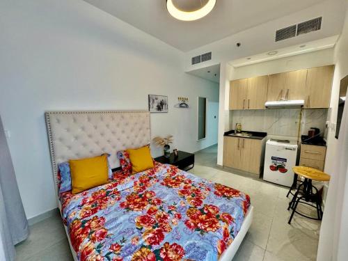 a bedroom with a large bed with yellow and red pillows at Stunning studio with balcony close to metro in Dubai