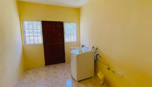 a small room with a sink and a window at Ocean JB Tower Isle in Tower Isle