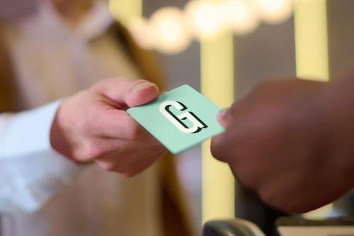 a person holding a piece of paper with the letter e on it at Garner Hotel Liberty Lake by IHG in Liberty Lake