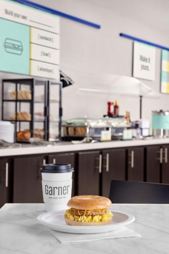 a sandwich on a plate next to a cup of coffee at Garner Hotel Liberty Lake by IHG in Liberty Lake