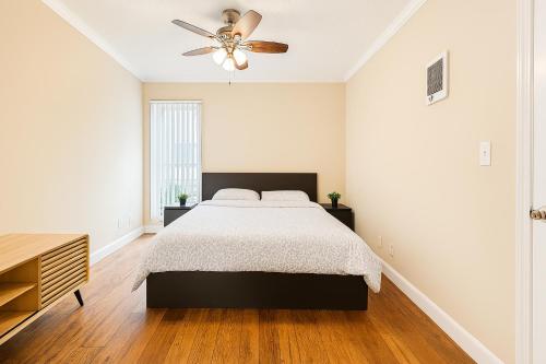 a bedroom with a bed and a ceiling fan at Ocean Haven Beachfront Getaway by Redondo Pier in Redondo Beach