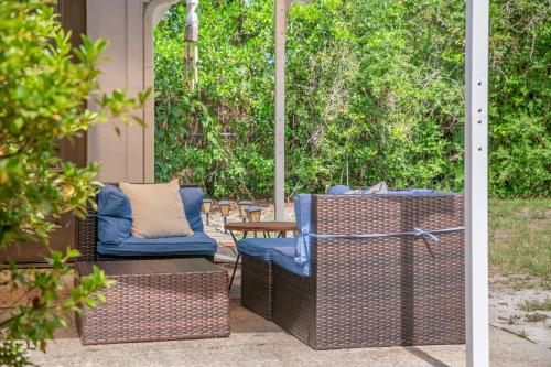 two wicker chairs and a table on a patio at Down By The Bay St Andrews Gem in Panama City