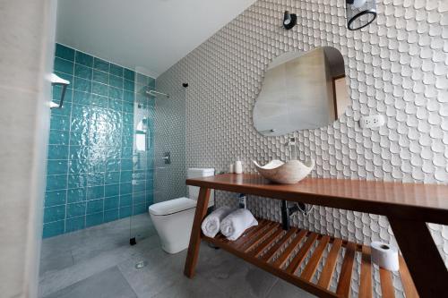 a bathroom with a sink and a toilet and a mirror at Aviva, brand new designer luxury villa in Vichayito
