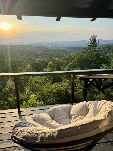 a white couch sitting on a deck with a view at Top of the Mountain Breathtaking Views Hot Tub in Blue Ridge