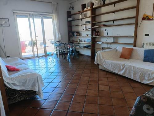 a living room with a couch and a table at Casa Panorama Viterbo Senza ZTL e Parcheggio Gratuito in Viterbo