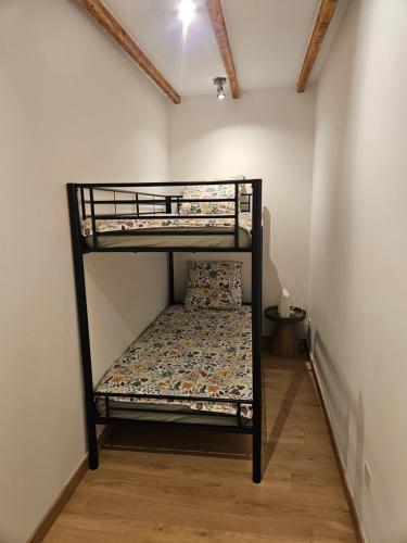 a bedroom with two bunk beds in a room at Appartement - mas provençal in Sernhac