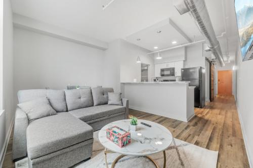 a living room with a couch and a table at Spacious DT Condo l Free Parking l Fast Wi-Fi in Cleveland