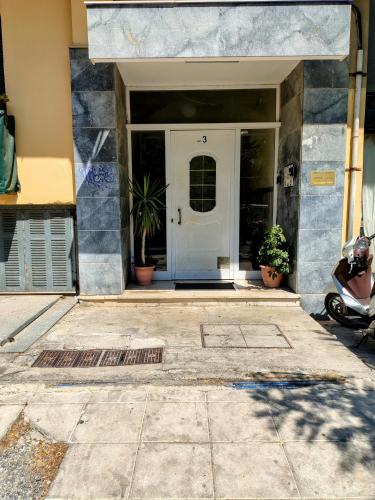 a front door of a house with potted plants at Casa Maritina in Agios Rokkos